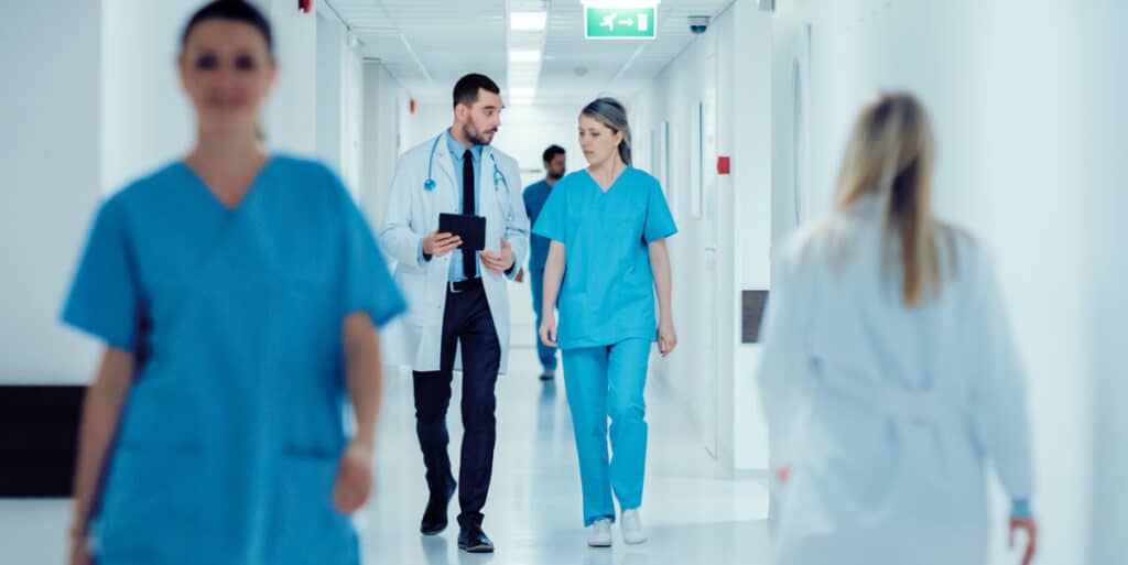 Hospital corridor with doctors and nurses